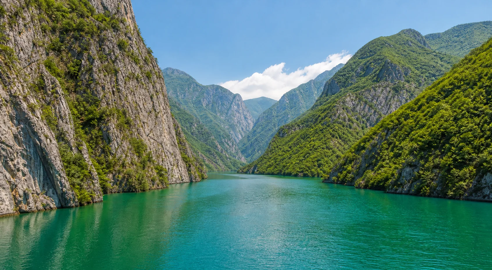 Komani Lake fjord surrounded by cliffs